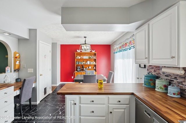 1234 Lamb Rd, Mason, MI 48854 - kitchen featuring butcher block countertops, white cabinetry, and tasteful backsplash