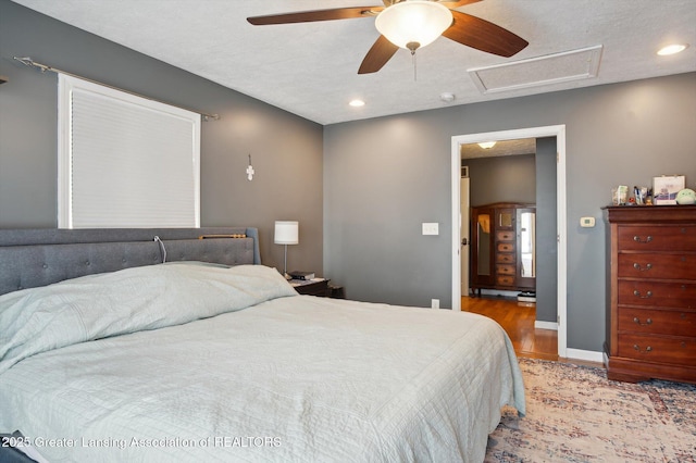 1234 Lamb Rd, Mason, MI 48854 - bedroom with wood finished floors, attic access, ceiling fan, recessed lighting, and a textured ceiling