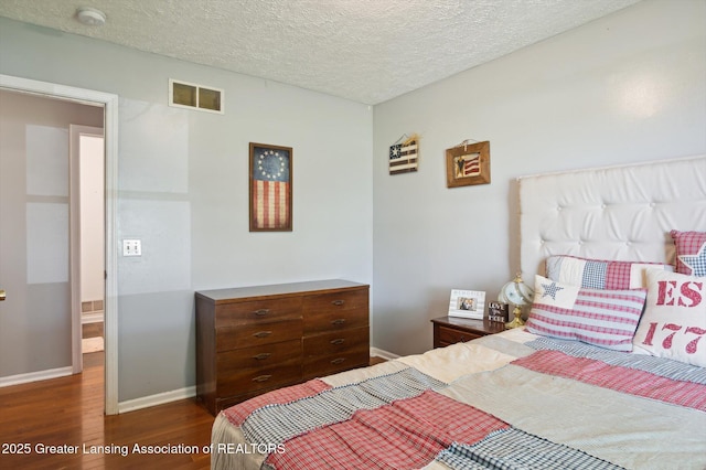 1234 Lamb Rd, Mason, MI 48854 - bedroom featuring wood finished floors and a textured ceiling