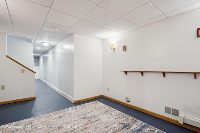 1234 Lamb Rd, Mason, MI 48854 - empty room with a paneled ceiling, stairs, a baseboard heating unit, and a smoke detector