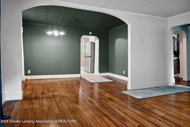 229 Rockingham Ave, Alma, MI 48801 - spare room with crown molding, hardwood / wood-style floors, and arched walkways