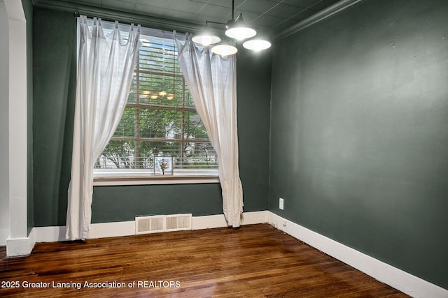 229 Rockingham Ave, Alma, MI 48801 - unfurnished room with baseboards and dark wood finished floors