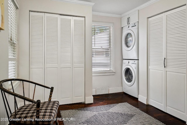 229 Rockingham Ave, Alma, MI 48801 - laundry area with estacked washer and dryer, dark wood-type flooring, and crown molding