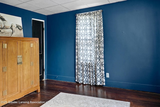 229 Rockingham Ave, Alma, MI 48801 - unfurnished bedroom featuring wood-type flooring and a drop ceiling