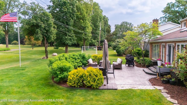 1717 Nottingham Rd, Lansing, MI 48911 - view of grassy yard featuring a patio area and an outdoor hangout area