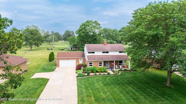 1717 Nottingham Rd, Lansing, MI 48911 - view of front of property featuring covered porch, concrete driveway, an attached garage, and a front lawn