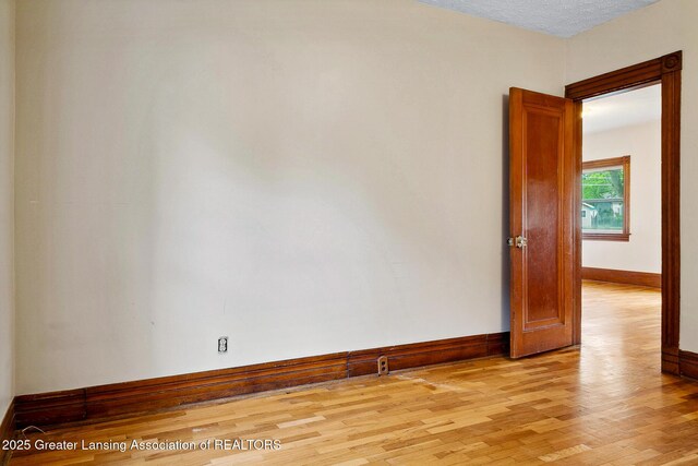 301 E Emerson St, Ithaca, MI 48847 - empty room with light wood-style flooring and baseboards