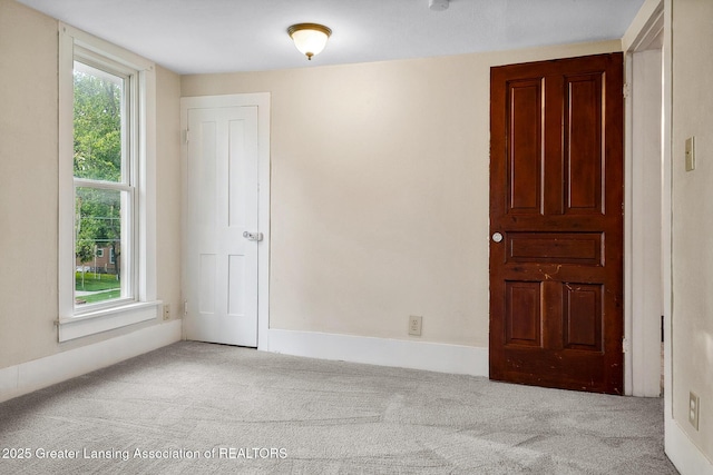 301 E Emerson St, Ithaca, MI 48847 - spare room with carpet floors