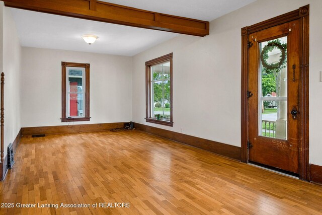 301 E Emerson St, Ithaca, MI 48847 - entrance foyer featuring light wood finished floors and beam ceiling
