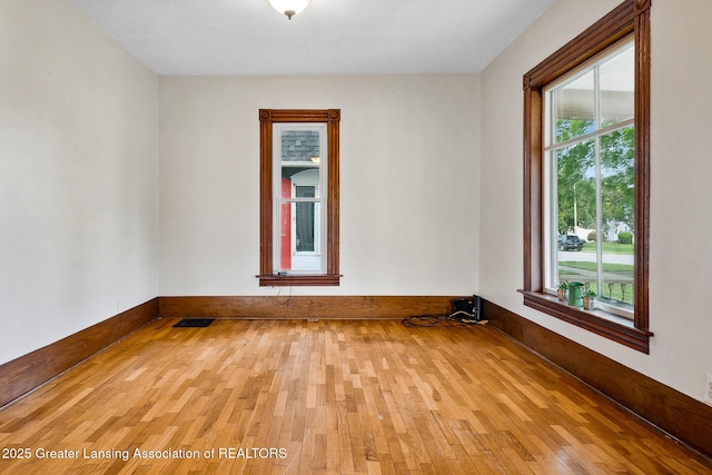 301 E Emerson St, Ithaca, MI 48847 - spare room featuring wood-type flooring