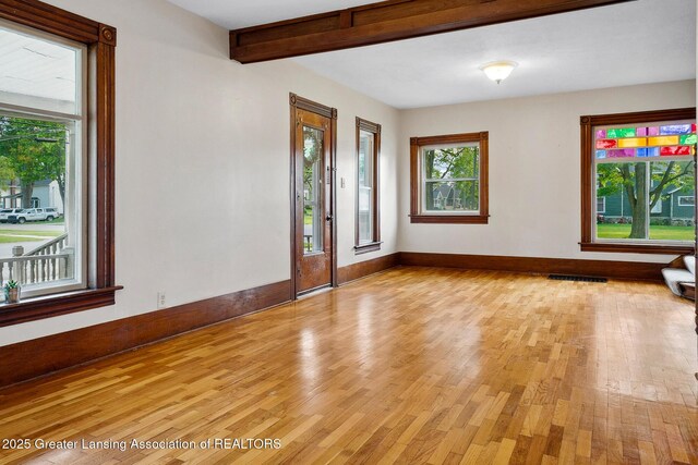 301 E Emerson St, Ithaca, MI 48847 - entryway featuring light wood-style floors and beamed ceiling