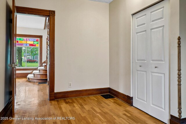 301 E Emerson St, Ithaca, MI 48847 - hall featuring baseboards and wood finished floors