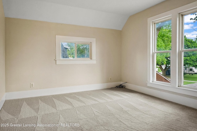 301 E Emerson St, Ithaca, MI 48847 - unfurnished room featuring carpet and lofted ceiling