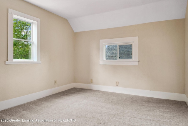 301 E Emerson St, Ithaca, MI 48847 - carpeted spare room featuring vaulted ceiling and baseboards