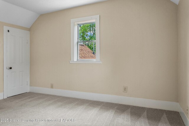 301 E Emerson St, Ithaca, MI 48847 - additional living space featuring carpet and vaulted ceiling