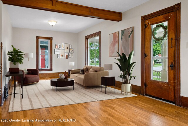 301 E Emerson St, Ithaca, MI 48847 - living room featuring light wood finished floors and beamed ceiling