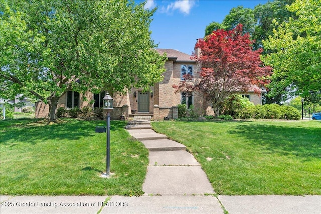 3886 Hemmingway Dr, Okemos, MI 48864 - obstructed view of property featuring a front yard and brick siding