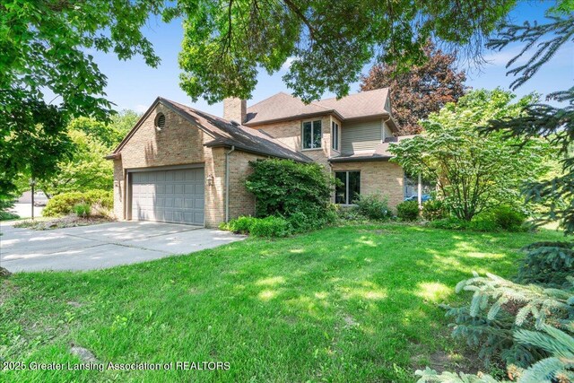 3886 Hemmingway Dr, Okemos, MI 48864 - view of front of home with a garage, concrete driveway, brick siding, a front lawn, and a chimney