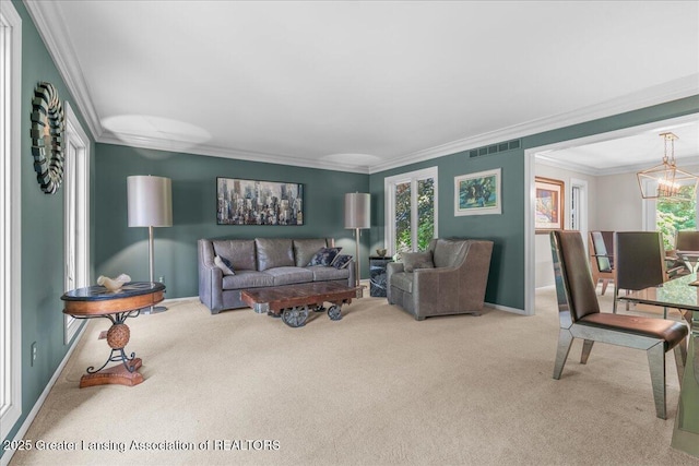 3886 Hemmingway Dr, Okemos, MI 48864 - carpeted living room with crown molding and a chandelier