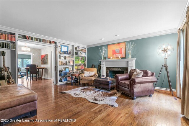 3886 Hemmingway Dr, Okemos, MI 48864 - living area with crown molding, wood finished floors, and a tile fireplace