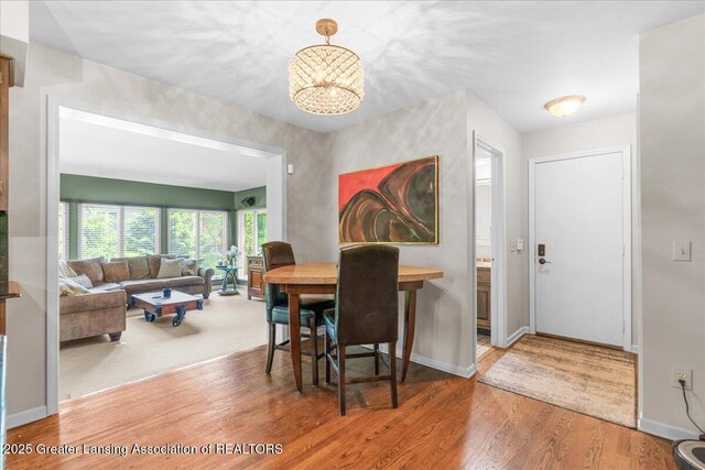 3886 Hemmingway Dr, Okemos, MI 48864 - dining area with wood finished floors and a chandelier