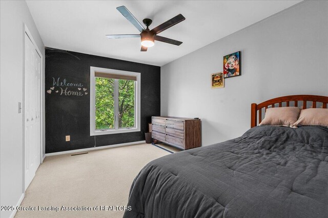 3886 Hemmingway Dr, Okemos, MI 48864 - carpeted bedroom featuring baseboards and a ceiling fan