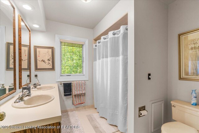 3886 Hemmingway Dr, Okemos, MI 48864 - bathroom with double vanity and a shower with curtain