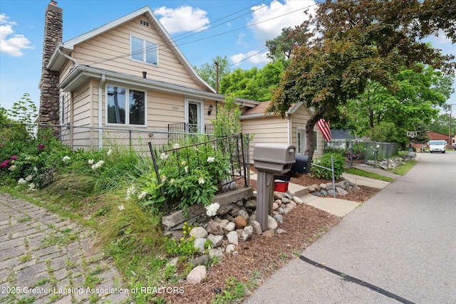 15754 Culver Dr, East Lansing, MI 48823 - bungalow-style house featuring a chimney