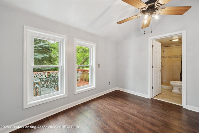 15754 Culver Dr, East Lansing, MI 48823 - unfurnished bedroom with dark wood finished floors, vaulted ceiling, connected bathroom, and a ceiling fan