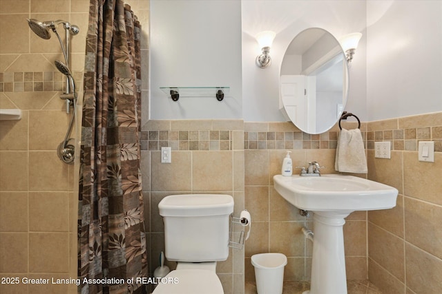 15754 Culver Dr, East Lansing, MI 48823 - bathroom featuring tile walls, a shower with shower curtain, and wainscoting