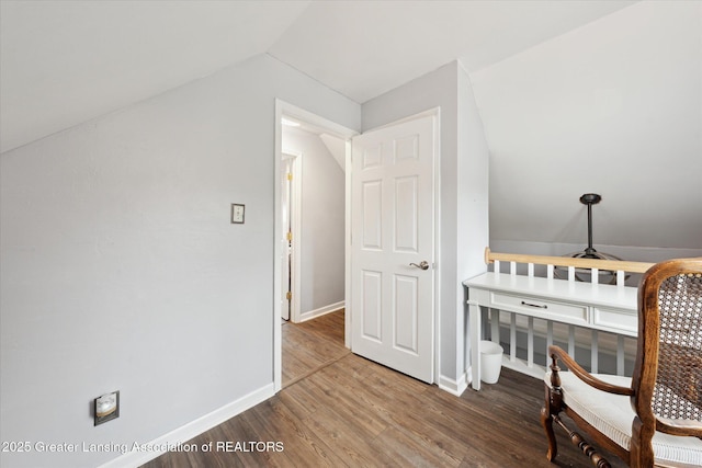 15754 Culver Dr, East Lansing, MI 48823 - living area featuring wood finished floors, a desk, and vaulted ceiling