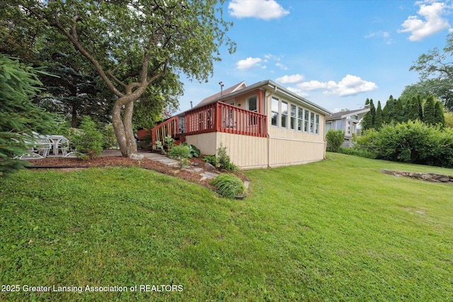 15754 Culver Dr, East Lansing, MI 48823 - view of side of home with a wooden deck and a yard