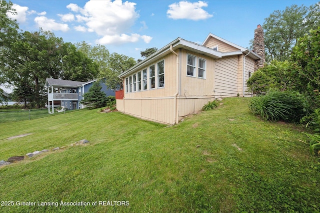 15754 Culver Dr, East Lansing, MI 48823 - view of home's exterior with a yard and a chimney