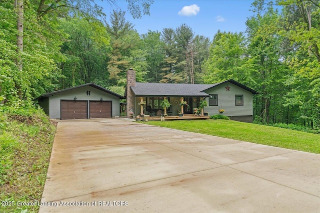 11100 S Bird Rd, Dowling, MI 49050 - view of front of property featuring a chimney, covered porch, a garage, an outdoor structure, and a front lawn
