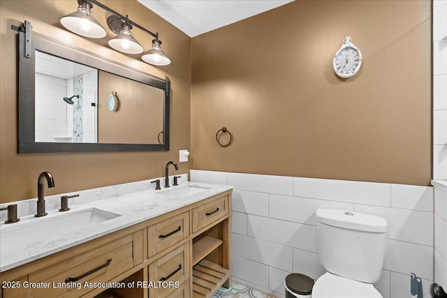 11100 S Bird Rd, Dowling, MI 49050 - full bath with double vanity, tile walls, and wainscoting