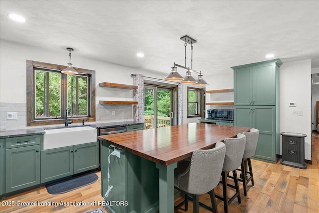 11100 S Bird Rd, Dowling, MI 49050 - kitchen with green cabinetry, open shelves, stainless steel microwave, and recessed lighting