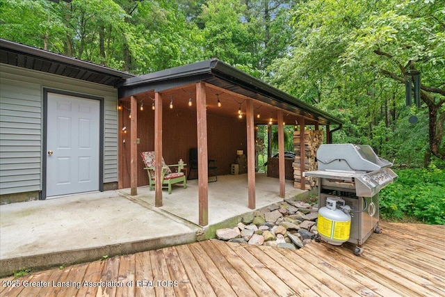 11100 S Bird Rd, Dowling, MI 49050 - wooden deck with a patio and area for grilling