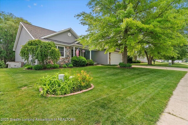 2308 Keller Rd, Holt, MI 48842 - view of property hidden behind natural elements featuring a garage, a front yard, stone siding, and concrete driveway