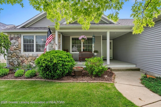 2308 Keller Rd, Holt, MI 48842 - doorway to property featuring covered porch, stone siding, roof with shingles, and a yard
