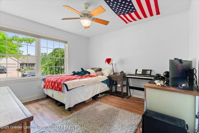 2308 Keller Rd, Holt, MI 48842 - bedroom with wood finished floors and ceiling fan