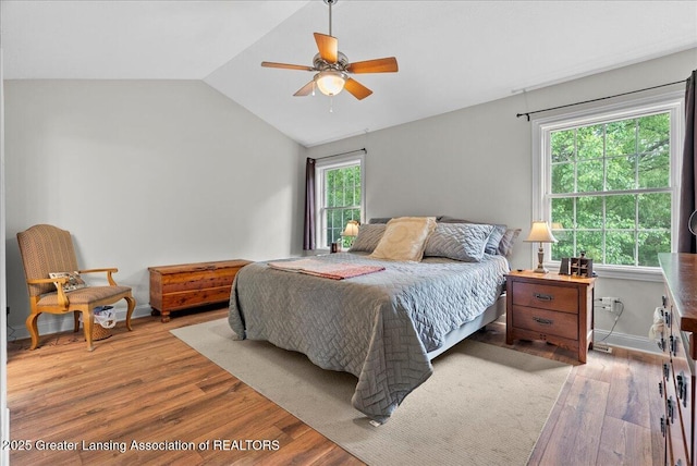 2308 Keller Rd, Holt, MI 48842 - bedroom with wood finished floors, vaulted ceiling, and ceiling fan
