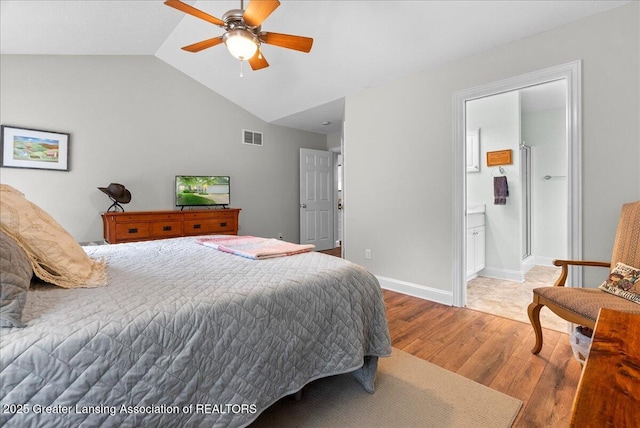 2308 Keller Rd, Holt, MI 48842 - bedroom with wood finished floors, lofted ceiling, a ceiling fan, and connected bathroom