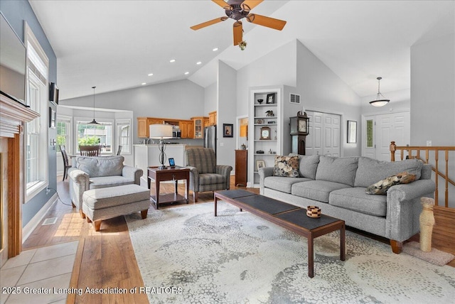 2308 Keller Rd, Holt, MI 48842 - living area with light wood-style floors, high vaulted ceiling, a ceiling fan, built in shelves, and recessed lighting