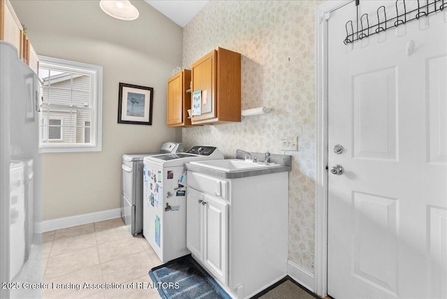 2308 Keller Rd, Holt, MI 48842 - washroom with wallpapered walls, washing machine and dryer, cabinet space, and light tile patterned floors