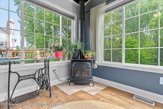 2308 Keller Rd, Holt, MI 48842 - sunroom / solarium with a wood stove and plenty of natural light