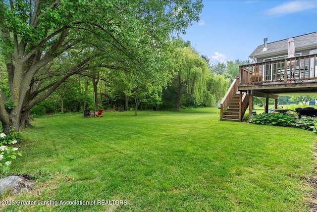 2308 Keller Rd, Holt, MI 48842 - view of grassy yard featuring stairway and a wooden deck