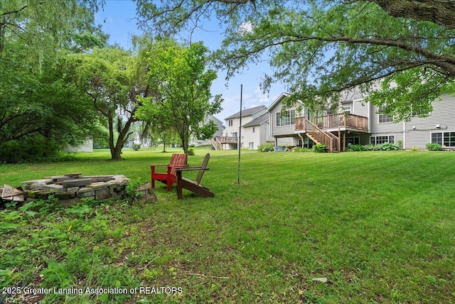 2308 Keller Rd, Holt, MI 48842 - view of grassy yard with an outdoor fire pit, stairs, and a deck