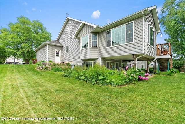 2308 Keller Rd, Holt, MI 48842 - rear view of house featuring a yard and a wooden deck