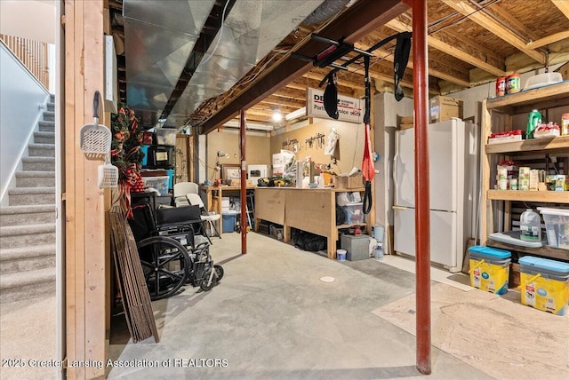 2308 Keller Rd, Holt, MI 48842 - unfinished below grade area featuring freestanding refrigerator and stairs