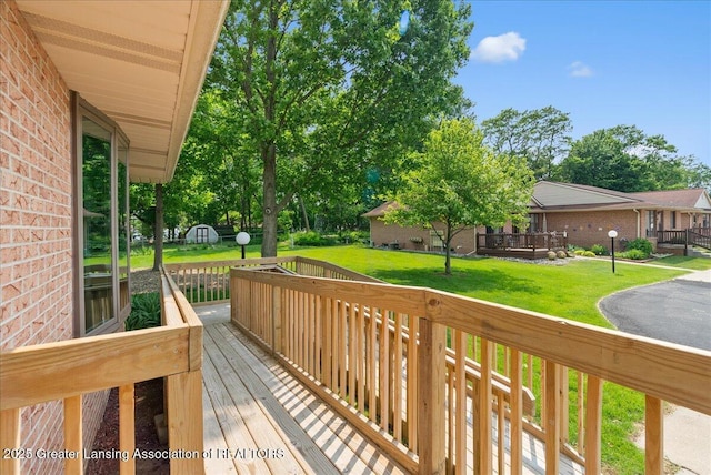 235 Bonnie Brook Dr Unit 1, Charlotte, MI 48813 - wooden terrace with a yard